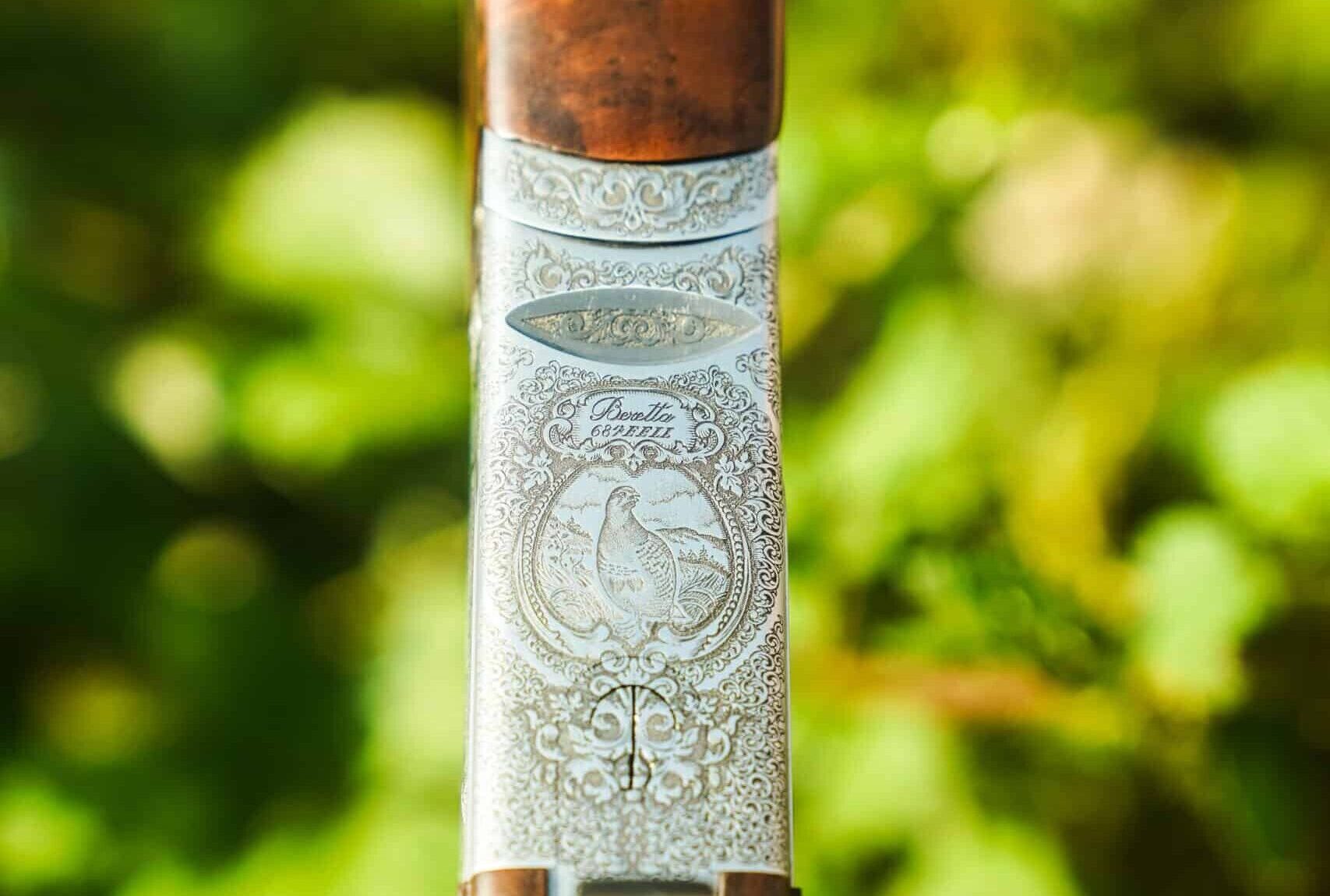 Beretta 687 EELL Combo shotgun with interchangeable 28-gauge and .410 barrel sets, featuring a game scene engraved side-plated action and specially selected walnut stock.